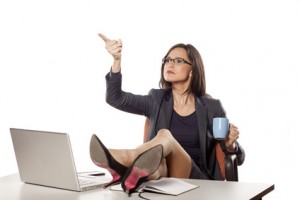 angry businesswoman with legs on the table command to others
